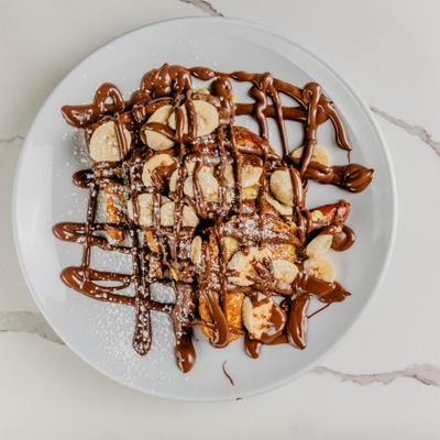 Nutella banana french toast drizzled with chocolate sauce.