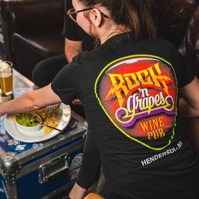 A person wearing Rock N Grapes Wine Pub t shirt.