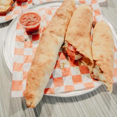Pepperoni and Italian Sausage  Calzone served with marinara sauce.