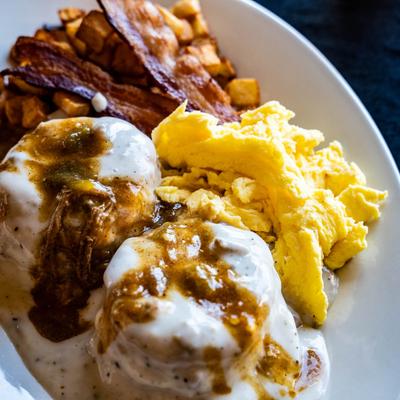 Biscuits Plus served with bacon, potatoes, and scrambled eggs.