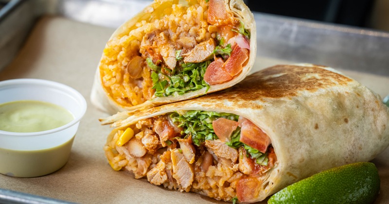 Burrito halves filled with rice meat and vegetables