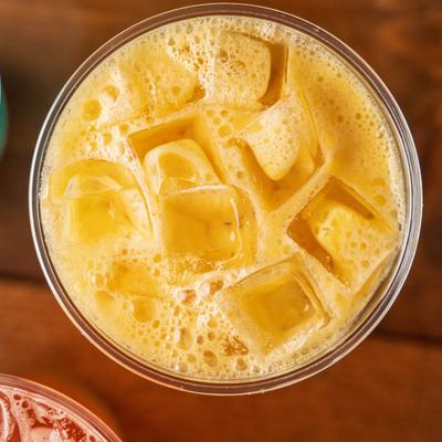 An orange iced drink, top view.