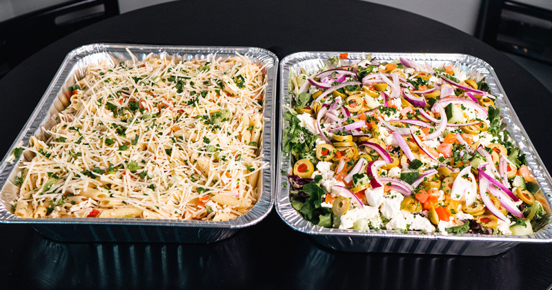 Pasta and Greek salads, catering serving