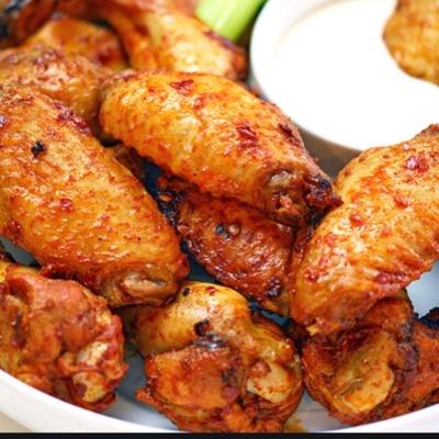 Close-up of Cajun wings with a cup of ranch dip.