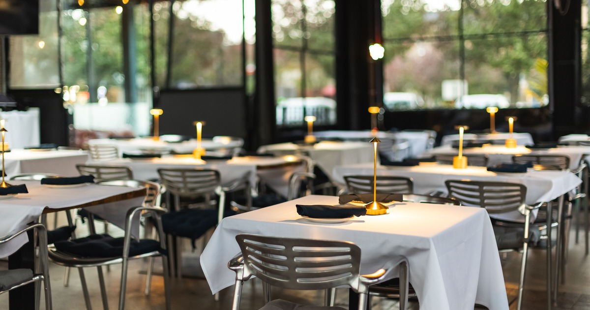 Dining tables at the semi-outdoor dining area ready for guests, close up