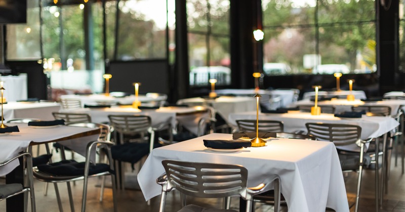 Dining tables at the semi-outdoor dining area ready for guests, close up