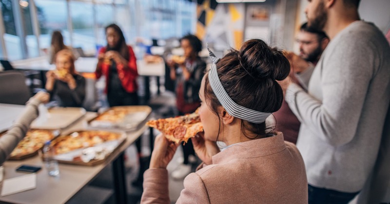 Customers eating pizza