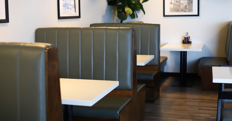 Interior, dining area, seating booths with tables, framed pictures on the wall