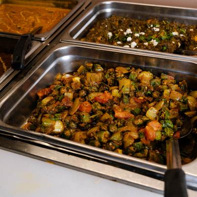 Okra cooked with special spices and tomatoes in a catering tray.