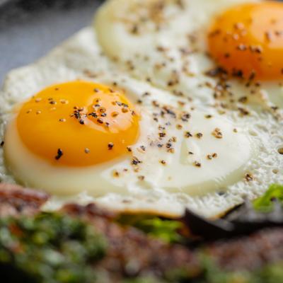 Two fried eggs as a part of the dish, close-up.