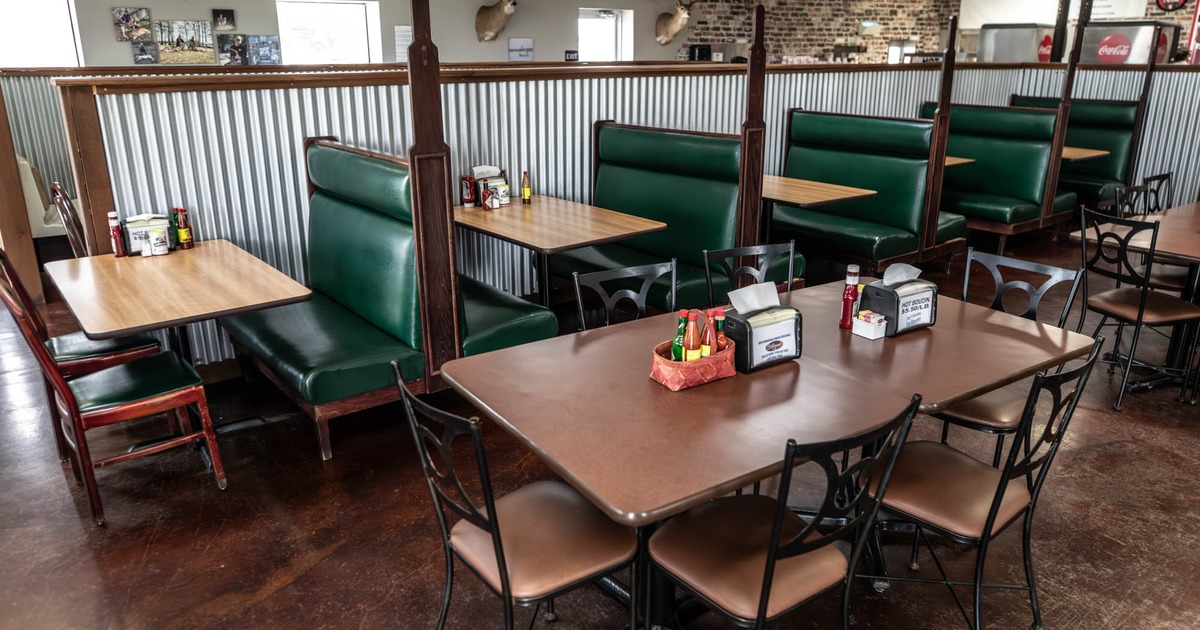 Interior seating area with chairs, tables and double booths