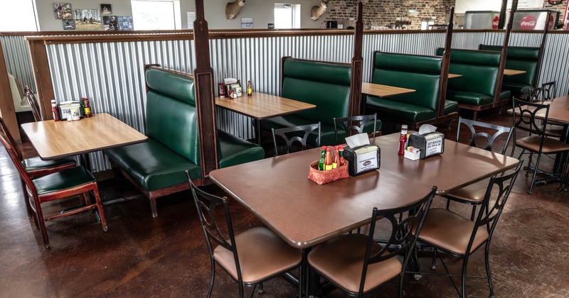 Interior seating area with chairs, tables and double booths