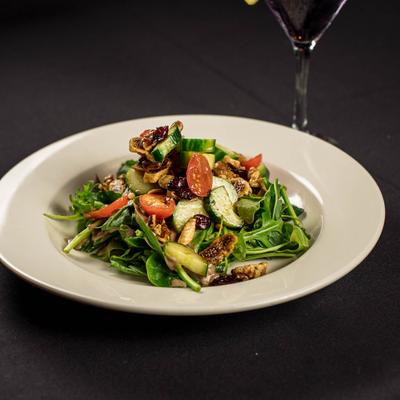 Arugula salad with figs, cucumbers, cherry tomatoes, and dried cranberries.