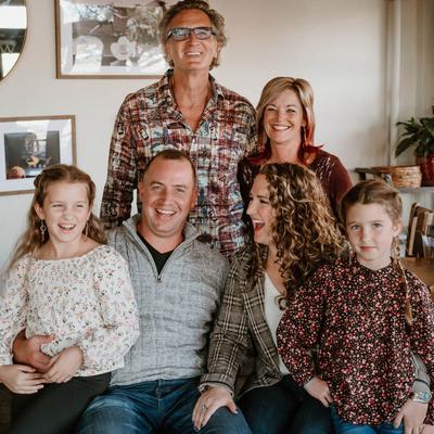 Group portrait of the owners with their family inside