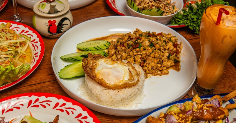 Ka-Pow served with a side of rice topped with a fried egg and fresh cucumber slices