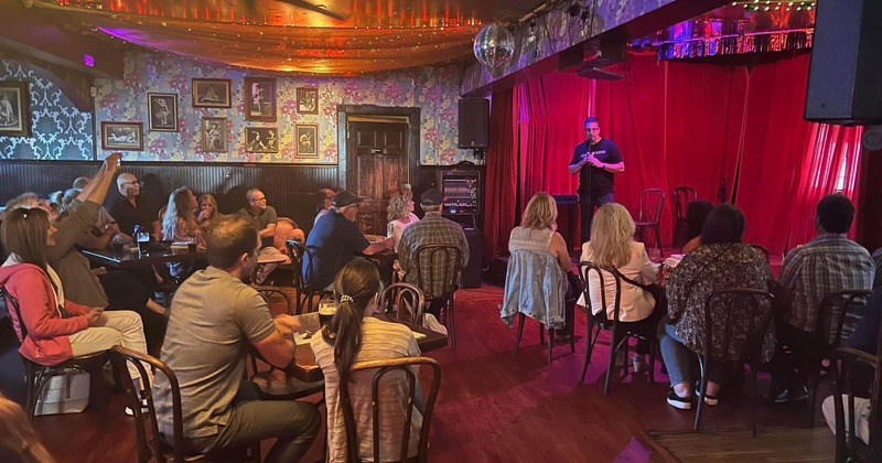 Interior, seated audience following a speech