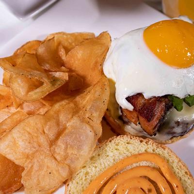 Snacks and burger with meat, cheese and fried egg