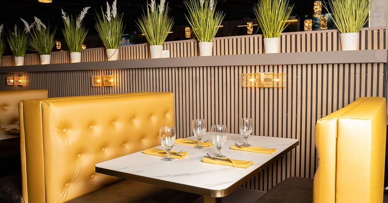 Upholstered dining booth set for four guests