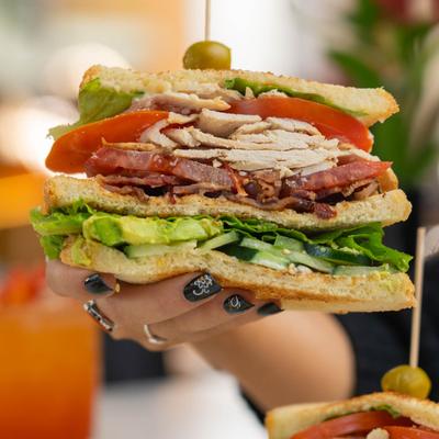 Club sandwich with chicken, bacon, lettuce, tomato, and avocado.