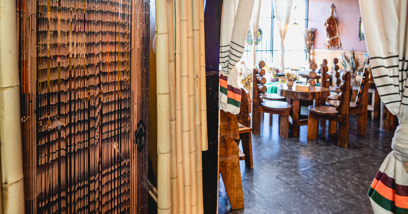 Entrance to the seating area with bamboo branch decor