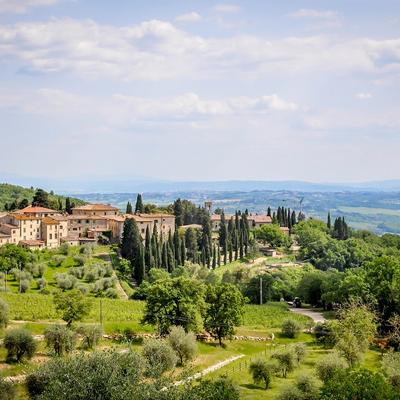 Rolling hills surrounding a Tuscan village.