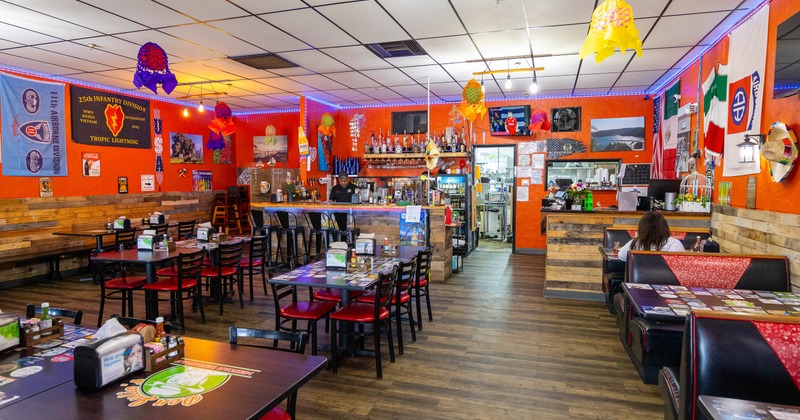 Interior, spacious dining area with tables, chairs and restaurant booths