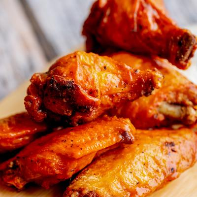 A plate of chicken wings, close up.
