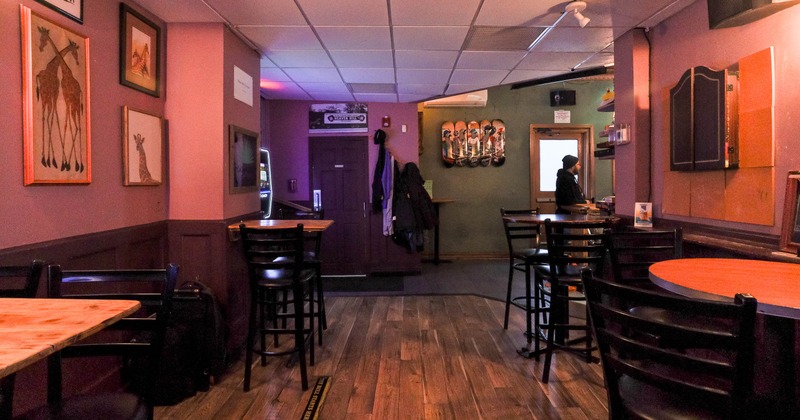 Bar interior with high-top tables and stools