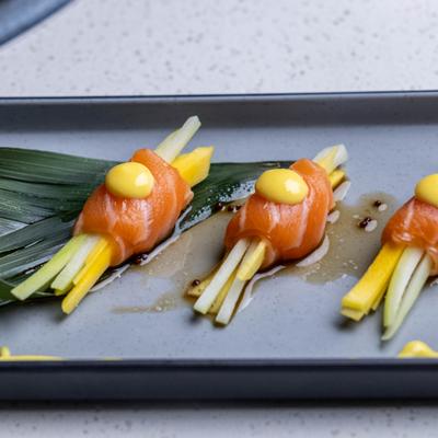 Mango Salmon featuring salmon sashimi wrapped around julienned mango and cucumber.