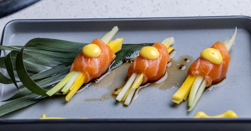 Mango Salmon appetizer featuring, raw salmon, sliced mango and cucumber