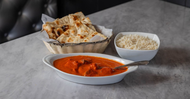 Chicken tikka massala served with rice and naan bread