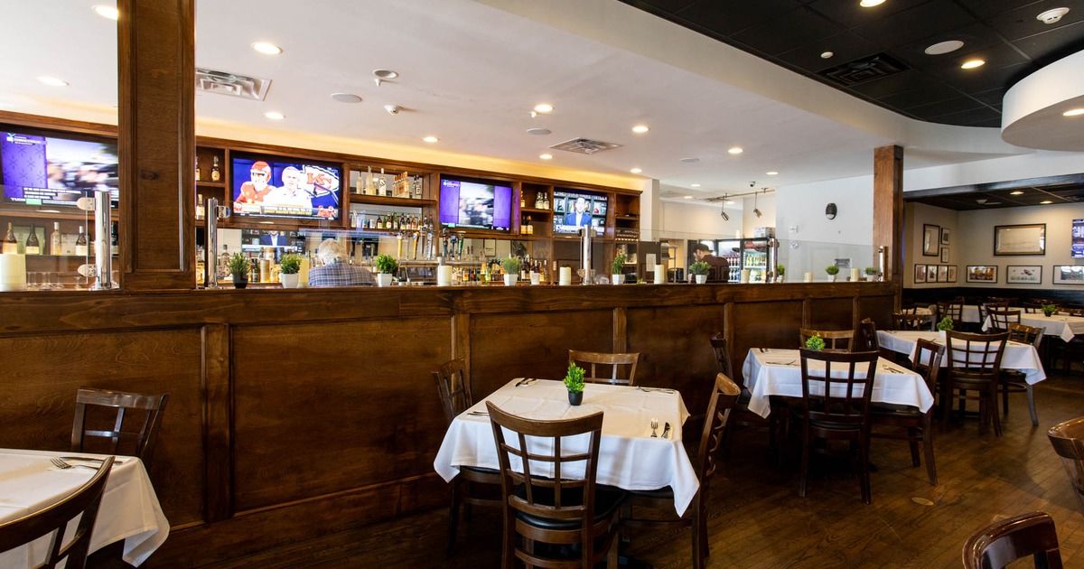 Interior, dining area, white cloth tables for four, wooden flooring, large room divider