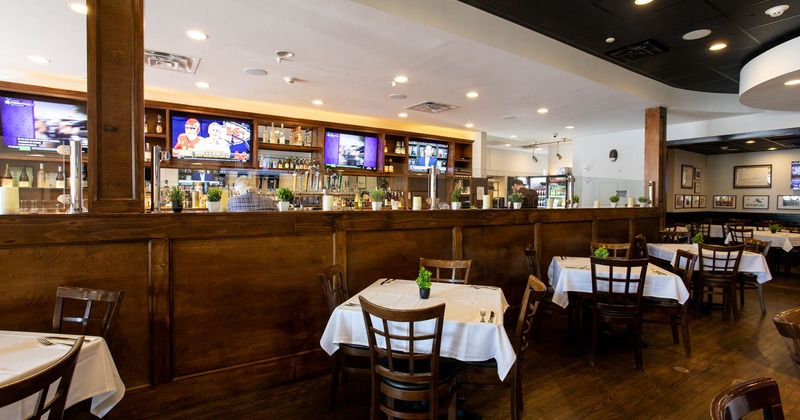 Interior, dining area, white cloth tables for four, wooden flooring, large room divider
