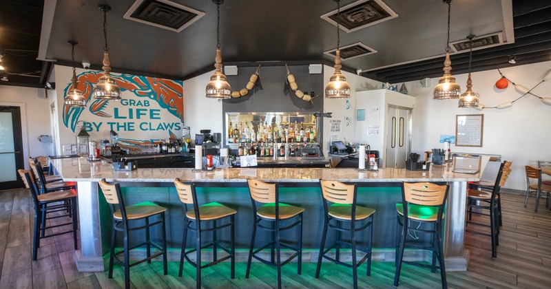 Interior, bar, chairs, sign on the wall behind