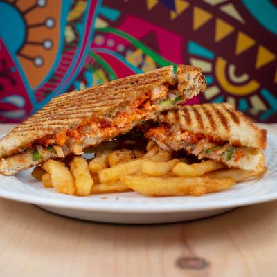 Grilled sandwich with a side of fries.