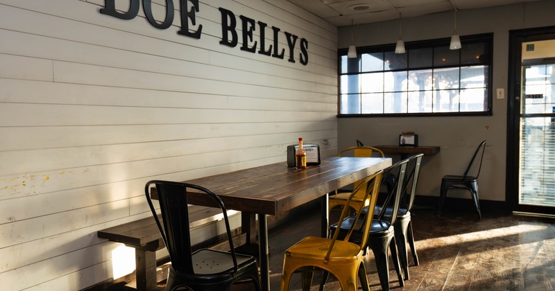 Restaurant interior with a wooden table, mixed metal chairs