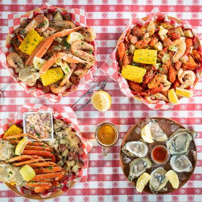 Seafood dishes and drinks on a table.