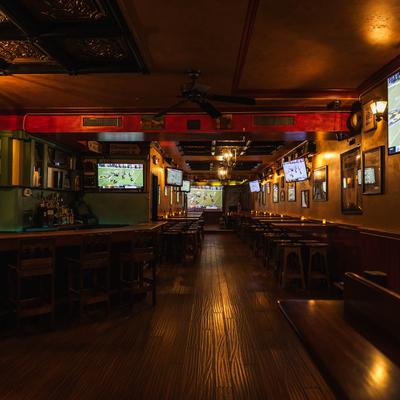 Interior with wooden tables, chairs, and dim light.