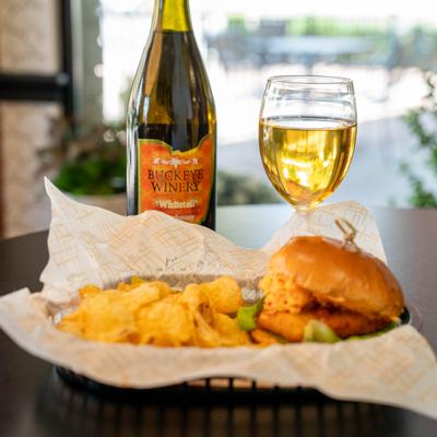 Fried chicken sandwich with pimento cheese and potato chips.