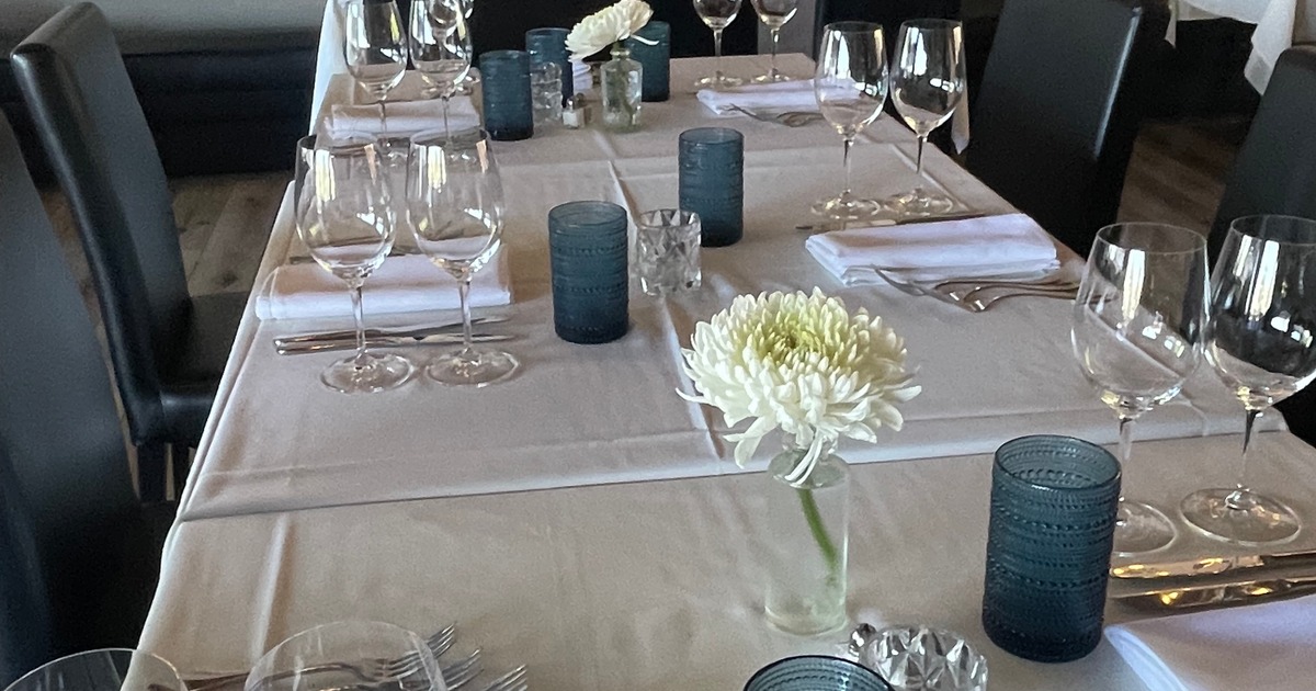 Dining table with place settings and decorative centerpiece