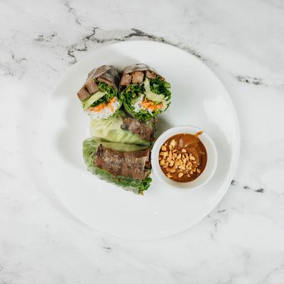 Grilled beef rolls served with a peanut dipping sauce.