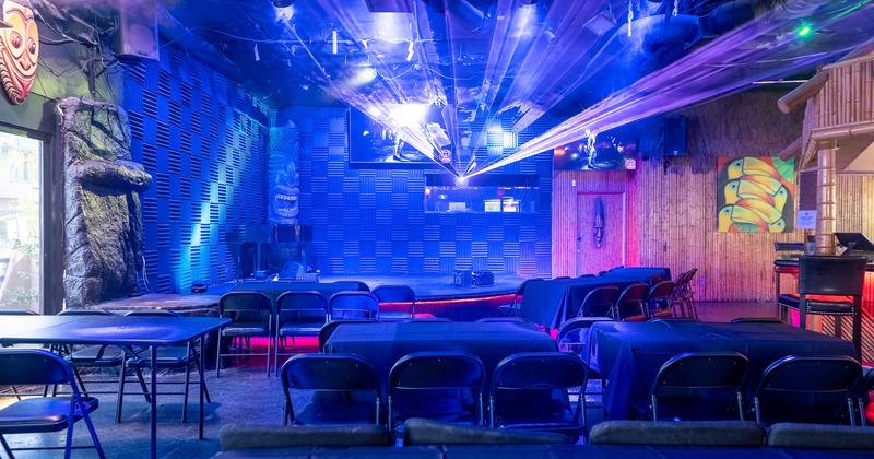 Interior of a dimly lit venue with blue and purple lights
