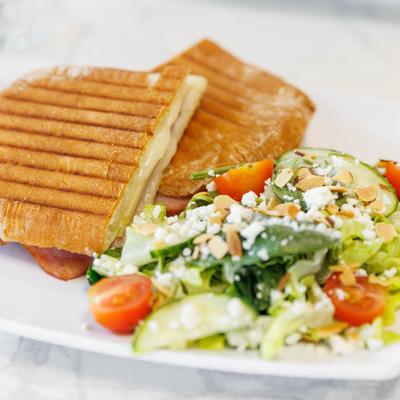 Grilled cheese panini with fresh salad.
