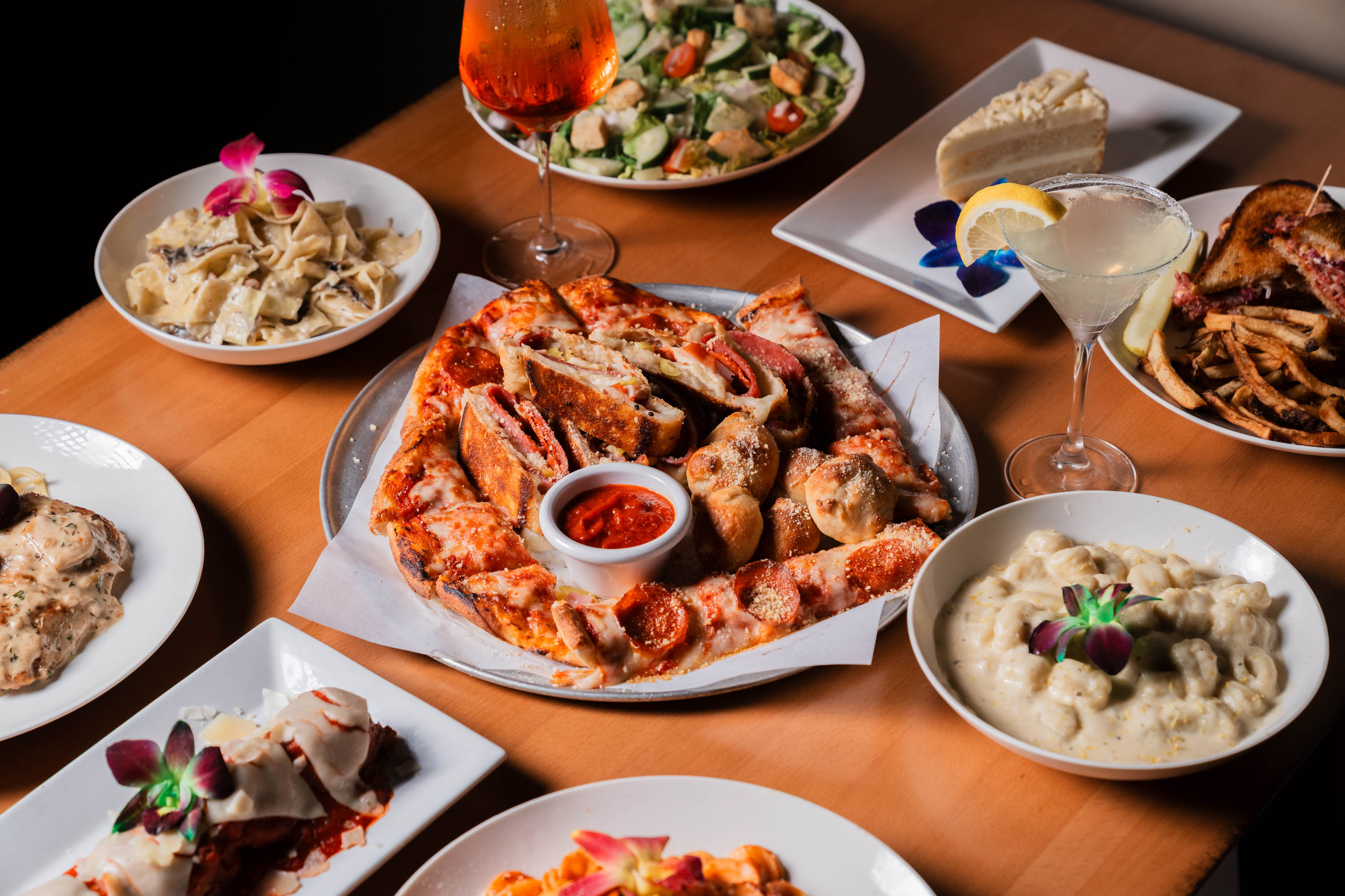 Shareable Pizza Platter served alongside other dishes and cocktails