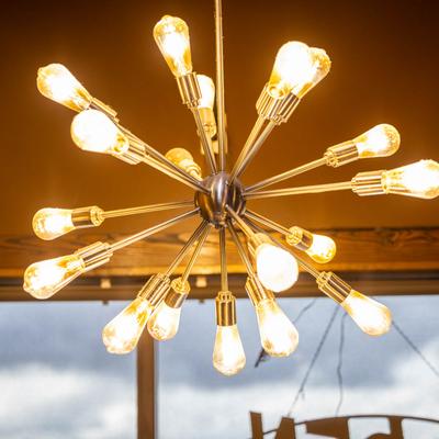 Lit atom-like pendant light.