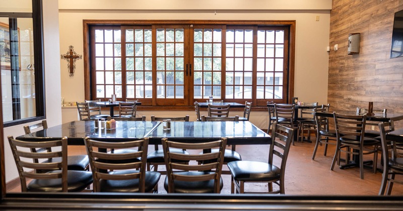 Interior, dining area, tables for eight and four people, large wooden sliding windows