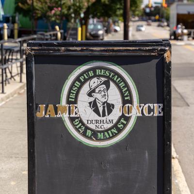 A sidewalk sign with the restaurant's logo.
