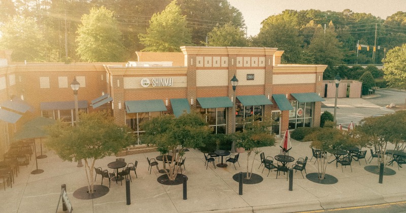 Outdoor seating area with tables and chairs