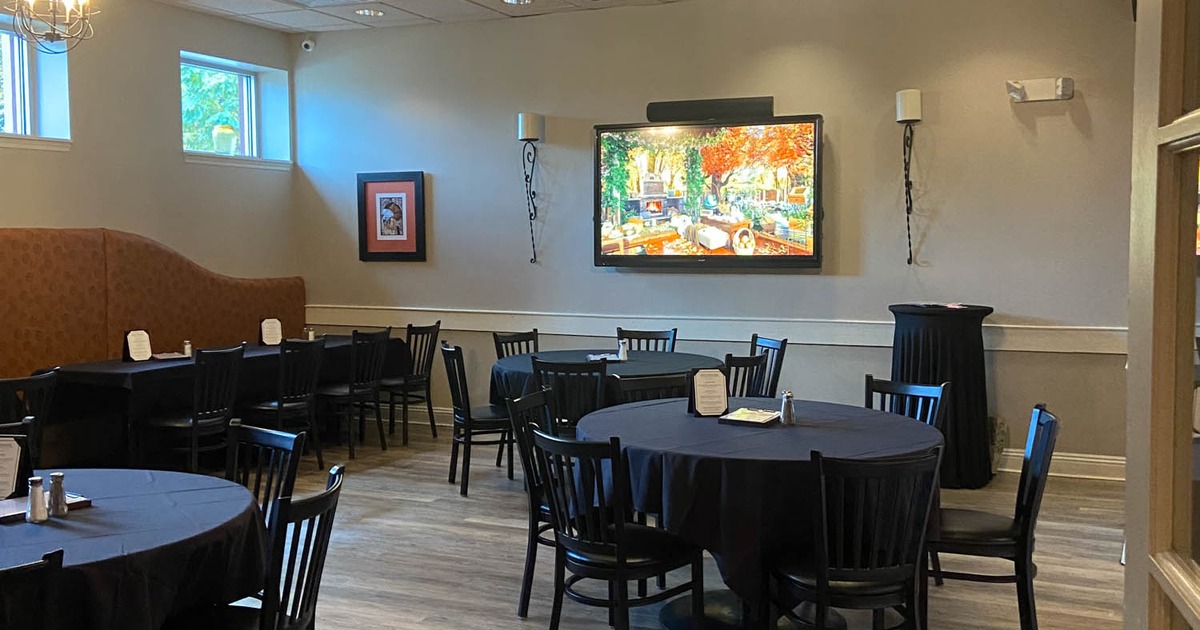 Interior, dining tables, chairs, TV on the wall