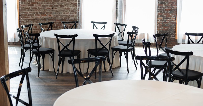 Interior setting featuring a round table with a white tablecloth